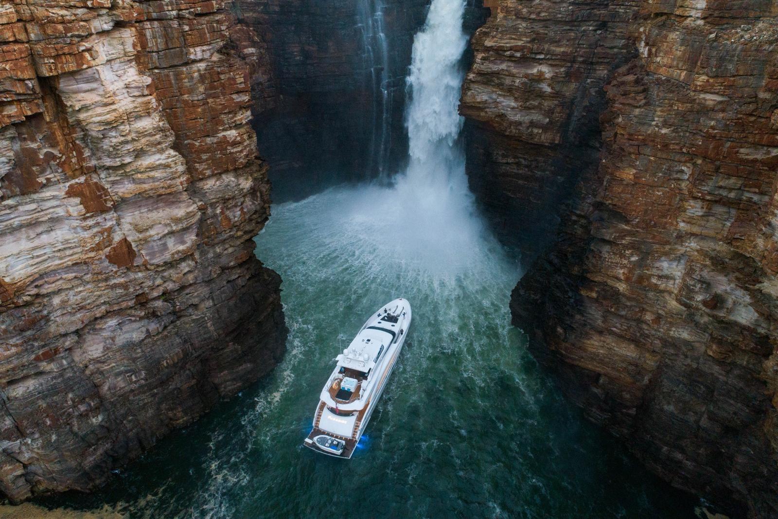Yacht sitting under waterfall