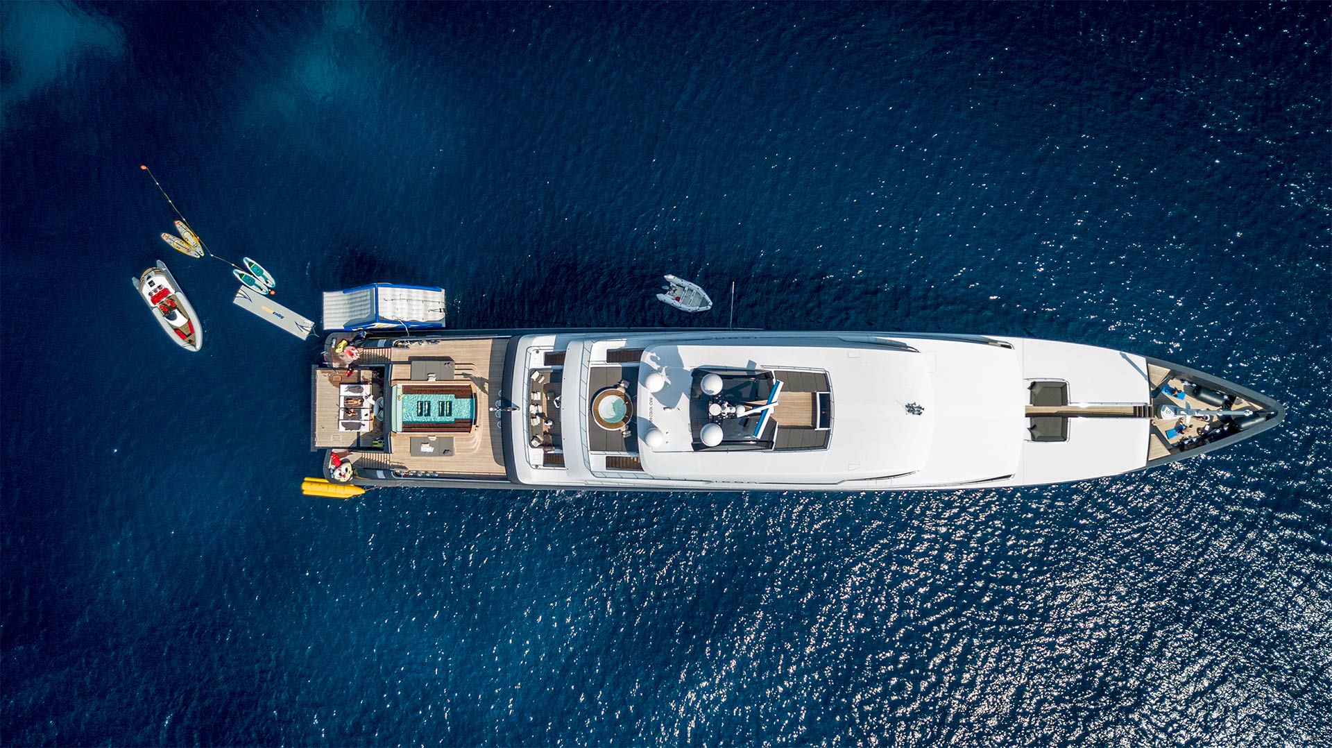Birds eye view of super yacht surrounded by blue sea